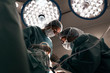 © Santi Nunez/Stocksy - Team of Surgeons Operating in the Hospital