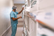 © Santi Nunez/Stocksy - Unrecognizable doctor working with boxes
