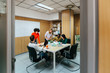 © MyMicrostock/Stocksy - Diverse people working in stylish office
