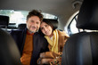 © ALTO IMAGES/Stocksy - Portrait Of Smiling Couple Traveling In Taxi