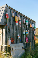 Buoys On The Outside Of A Shed In New England.
