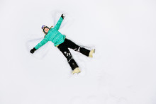 Teenage Skier Making A Snow Angel, Viewed From Above