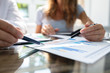 © Andrey Popov - Two Businesspeople Analyzing Graph