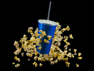 Canvas Print - Blue cup with cap and flying popcorn isolated on black background