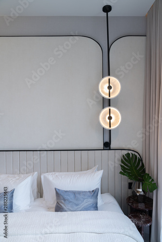 Minimal Bedroom Corner Wuth Circular Wall Lamp Installed On