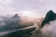 Mysterious River Landscape Among High Mountains In Haze