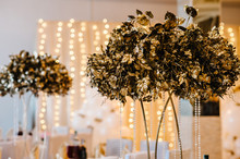 Dry Golden Bouquet Leaves On The Table On Light Background. Gold Wedding Reception.  Autumn Style. Luxury Elegant Wedding Decor For The Ceremony.