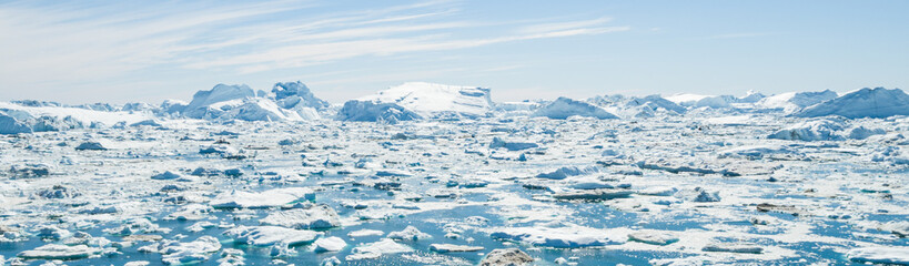 Wall Mural - Global Warming and Climate Change - Icebergs and ice from melting glacier in icefjord in Ilulissat, Greenland. Aerial photo of arctic nature ice landscape. Unesco World Heritage Site. Panoramic banner