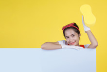 Cleaning Concept. A Beautiful Woman Holds A White Board To Put An Advertisement Message And Hold Cleaning Equipment On A Yellow Background.