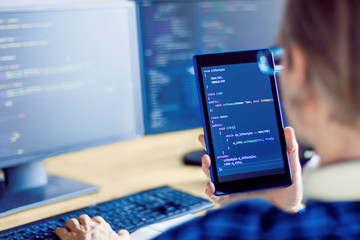 Wall Mural - closeup tablet screen with conceptual program code about healthy lifestyle in male hand. programmer 
