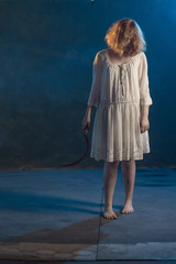 scary girl in white dress from horror film in  room