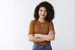 © Cookie Studio - Girl not scared challenging tasks. Successful happy confident good-looking curly-haired customer service manager woman cross arms chest smile assertive self-assured feel empowered relaxed