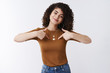 © Cookie Studio - Me who you need. Self-assured attractive cheerful curly-haired glad girl bragging pointing herself chest smiling delighted telling own achievement telling personal goals proud, white background