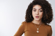 © Cookie Studio - Wow interesting. Intrigued sassy attractive sensual modern beautiful girl curly dark hair folding lips curious hear awesome tea gossiping likes hear last rumors, standing amused white background