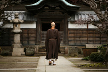A Monk In Court Yard Of A Monastery In Kamakura, Japan.