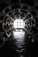 Wall Mural - exit from the drainage sewage tunnel. concrete drainage collector of city sewage system