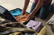 © Viktor Koldunov - Senior man hands packing clothes in suitcase. Get ready for vacation.