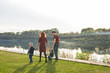 © satura_ - Parent, childhood and nature concept - Family playing with two sons by the water