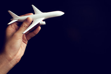 businessman hand holding an airplane toy model in transportation business for travel tourist international concept, summer season holiday vacation, logistic import export