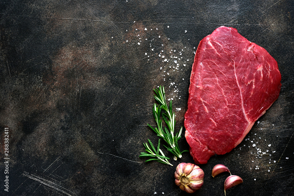 Raw beef steak with spices. Top view with copy space. - obrazy, fototapety, plakaty 