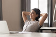 © fizkes - Happy peaceful asian female employee relaxing during working day break.