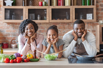 Wall Mural - Beautiful african american family making dinner together