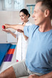 © Yakobchuk Olena - Happy male patient doing special gymnastics with dumbbell
