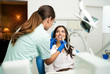 Young elegant woman sitting in dentist chair while dentist is working 