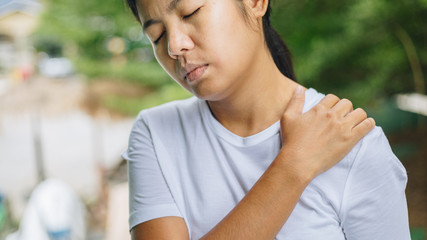 Wall Mural - Young asian woman has pain in shoulder , health care concept