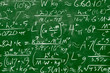 Math equations and formula written in chalk on green messy chalkboard background. School or scientific research concept.