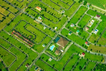 Aerial view of a new housing subdivision in the Philippines with many empty lots together with new buildings. Urban expansion and property development in southeast Asia.