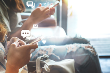 Two woman hand holding smartphone and using application social media. Social network sharing and commenting in the online community.