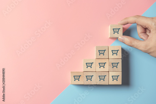 Fotografía sale volume increase make business grow, hand hold cube with icon shopping cart symbol