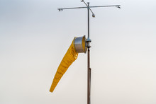 Yellow Windsock Against A Bright Sky Background