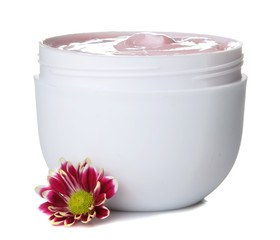 Wall Mural - Cream. cosmetics for face and body. Pink cream and flower in a white jar on a white isolated background