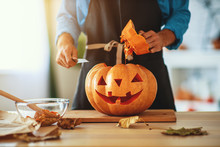 Hands Of  Man Cutting Pumpkin To Halloween.