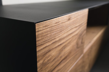 Closeup details of modern tv stand made from walnut and powder coated steed
