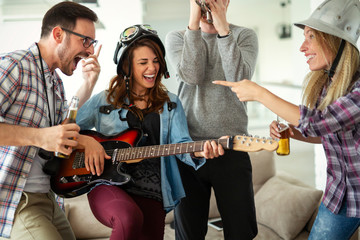 Wall Mural - Group of young friends having fun together and playing in music band