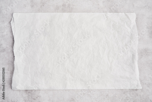 Cuadros en Lienzo Crumpled piece of white parchment or baking paper on grey concrete background