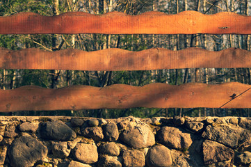 Wall Mural - Wood and stone background. wooden fence and natural stone wall in the park