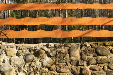 Wall Mural - Wood and stone background. wooden fence and natural stone wall in the park