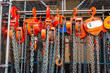 Multiple chain hoists hanging in a rack ready for use in a industrial environment, picture taken in the Netherlands