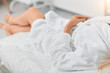 © alfa27 - close up cropped photo. woman in white bathrobe relaxing at the resort. blurred background