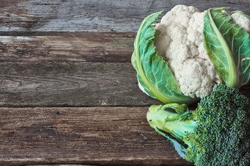 Wall Mural - Fresh farmer green broccoli and cauliflower head on an old rough wooden surface, healthy eating concept, selective focus