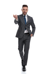 Wall Mural - smiling young businessman walks and welcomes