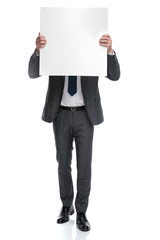 Canvas Print - businessman covers his head with a blank board