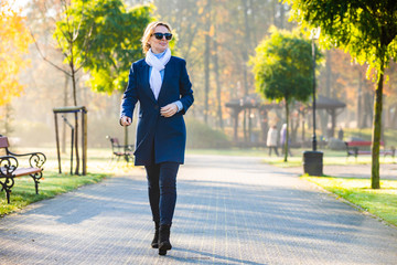 Wall Mural - middle-aged woman walking in city park