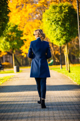 Wall Mural - middle-aged woman walking in city park