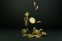 Falling One And Two British Pound Coins On A Black Background 