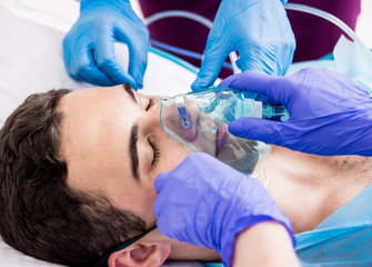 Wall Mural - Doctors give resuscitation to a male patient in the emergency room. Cardiac massage